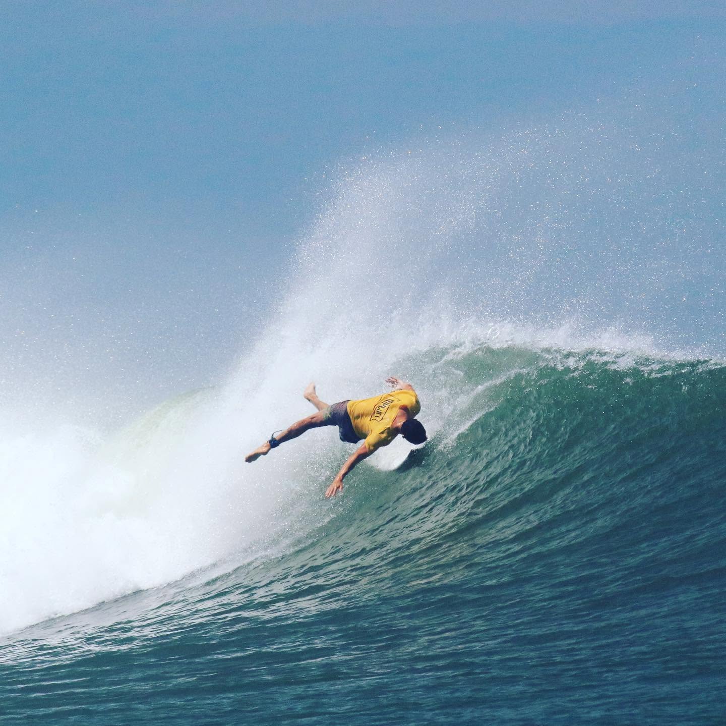 Surfer twisting through a powerful turn, a fitting reminder for post-surf massage recovery at Sirena Surf Lodge